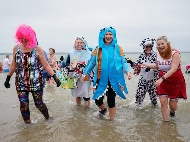 People take part in the Gosport New Year's Day Dip in The Solent at Stokes Bay, Gosport, Hampshire, to raise money for Gosport and Fareham Inshore Rescue Service.