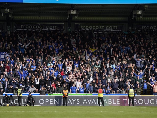 The travelling Pompey fans celebrate Colby Bishop's second goal in the 28th minute at Adams Park