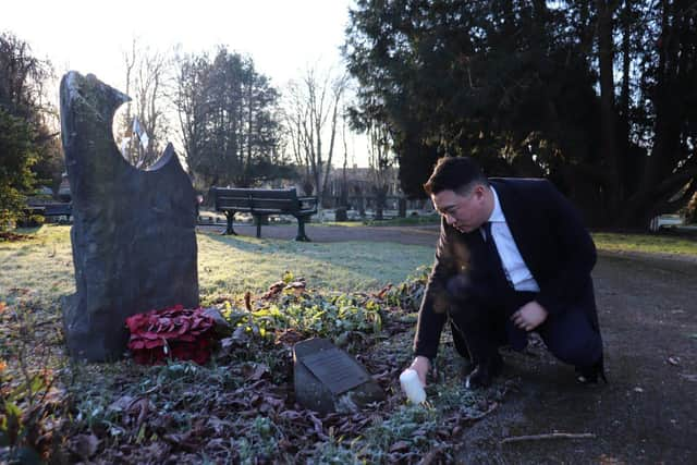 Alan Mak MP lights a candle in Havant Cemetery