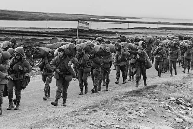 Argentine soldiers are seen 13 April 1982 in their way to occupy the captured Royal Marines base in Puerto Argentino/Port Stanley, a few days after the Argentine military dictatorship seized the islands Malvinas/Falklands, starting a war between the Argentina and the United  Kingdom.      AFP PHOTO Daniel GARCIA (Photo by DANIEL GARCIA / AFP) (Photo by DANIEL GARCIA/AFP via Getty Images)