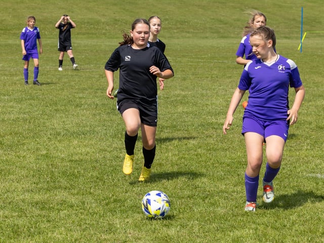 Stoneham Lionesses (purple kit) take on Bedhampton Hawks (black kit) in the Clanfield youth football tournament at Horndean Technology College. Picture: Mike Cooter