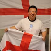 Havant MP Alan Mak with his England flags, sporting a new England shirt - so new it even has the tag on. Picture: Alex Rennie