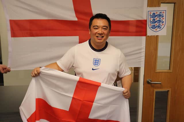 Havant MP Alan Mak with his England flags, sporting a new England shirt - so new it even has the tag on. Picture: Alex Rennie