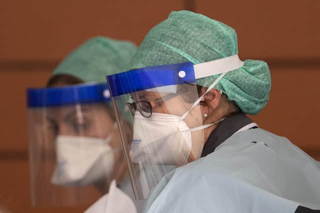 NHS workers in PPE attend to a patient at St Thomas' Hospital on April 10, 2020 in London, England.  (Photo by Justin Setterfield/Getty Images)
