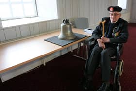 Marine Jim Wren and the bell of HMS Repulse. Picture: NMRN