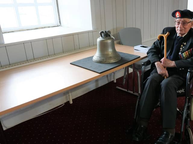 Marine Jim Wren and the bell of HMS Repulse. Picture: NMRN