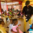 Hilsea personal trainer Warren Chebby delivered a container full of donated goods to people living in poverty in Burundi, where he grew up, through his organisation Bridge The Gap. Pictured: Warren handing out clothing to the children at SOS Orphanage
