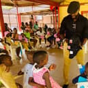 Hilsea personal trainer Warren Chebby delivered a container full of donated goods to people living in poverty in Burundi, where he grew up, through his organisation Bridge The Gap. Pictured: Warren handing out clothing to the children at SOS Orphanage