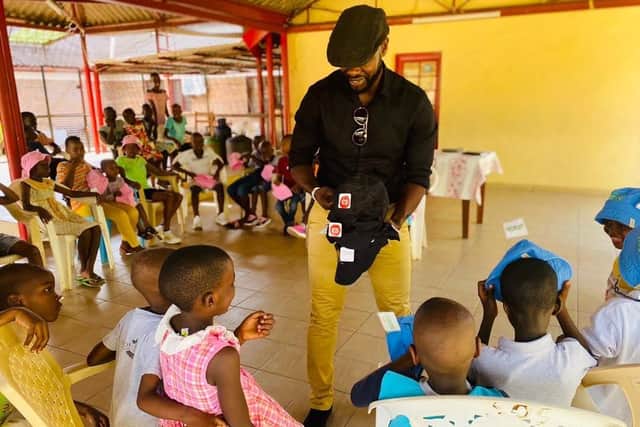 Hilsea personal trainer Warren Chebby delivered a container full of donated goods to people living in poverty in Burundi, where he grew up, through his organisation Bridge The Gap. Pictured: Warren handing out clothing to the children at SOS Orphanage