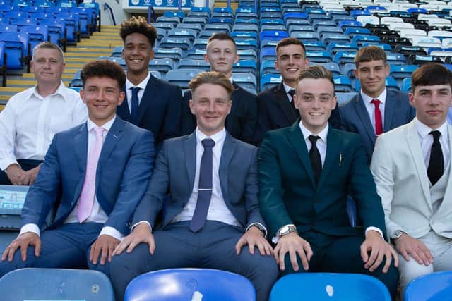 Alfie Stanley, third from left, with his Academy intake at Fratton Park.
Back row: Academy chief Mark Kelly, Haji Mnoga, Stanley, Harry Kavanagh, Stan Bridgman and coach Liam Daish.
Front row: Tom Bruce, Ethan Robb, Liam Kelly and Leon Pitman
