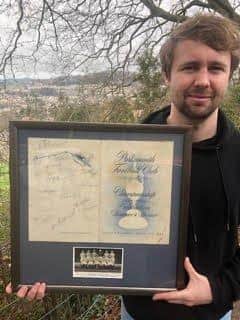 William holding the autographed menu