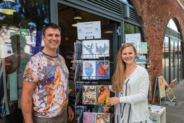 James Mouland (46) and Bahar Mouland (43) outside their Hotwalls Studio 13, with some of their original artworks. Picture: Mike Cooter (060821)