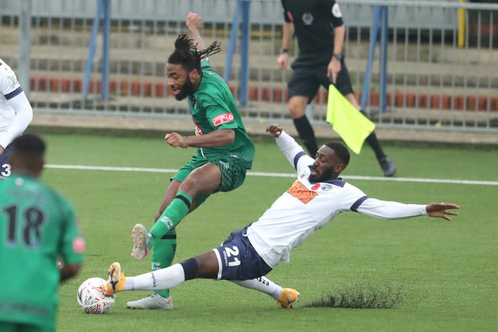 Roarie Deacon slides in to tackle Denzil Gayle during Hawks' 1-0 FA Cup first round win against Cray Valley at Westleigh Park. Pic: Dave Haines.