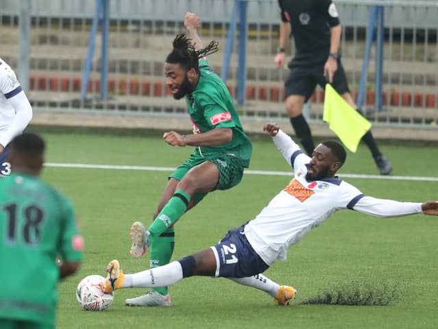 Roarie Deacon slides in to tackle Denzil Gayle during Hawks' 1-0 FA Cup first round win against Cray Valley at Westleigh Park. Pic: Dave Haines.