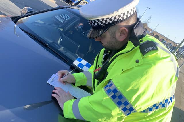 File photo of a Hampshire roads policing officer in Fareham issuing a ticket. Picture: Ben Fishwick