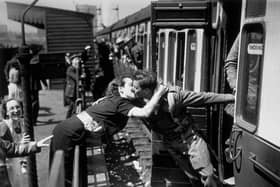 A soldier of the British Expeditionary Force, arriving back from Dunkirk, is greeted affectionately by his girlfriend.   (Photo by Topical Press/Getty Images)
