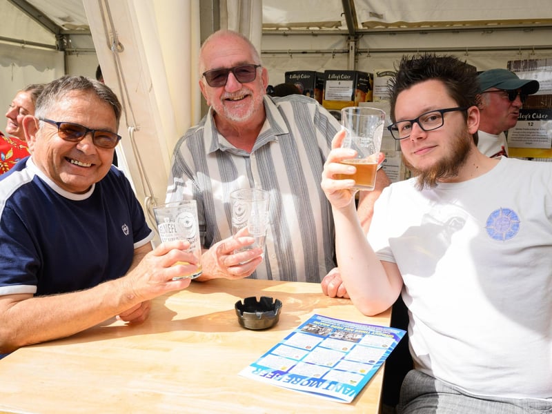 Cheers! Three pubgoers enjoy a drink in the sunshine.Picture: Keith Woodland (250521-11)