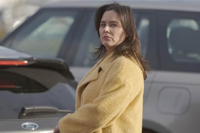 Lucy (Jill Halfpenny) sees something sinister as she heads for the supermarket in the new Channel 5 drama Number One Fan (Picture: Clapperboard/Channel 5)