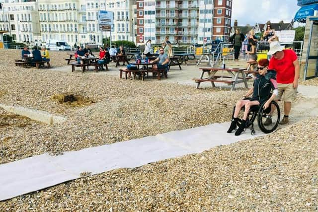 Laura Collinson from Eastney was able to go in the sea at Southsea for the first time in 25 years after the Accessible Beach Campaign For Pompey cleared away some shingle. Picture: Jonathan Schofield