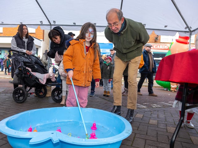 Locals braved the cold to celebrate the start of the Christmas festivites with a street party on Hayling Island on Saturday afternoon.
Pictured - Youngster Phoebe Sadler, 6 with her grandad playing Hook-A-Duck
Photos by Alex Shute