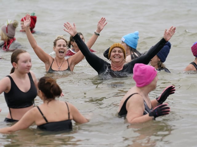 People take part in the Gosport New Year's Day Dip in The Solent at Stokes Bay, Gosport, Hampshire, to raise money for Gosport and Fareham Inshore Rescue Service.