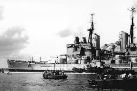 HMS Vanguard with the sea-going tug Advice on the port side attempting to halt her advance into Point. Picture: Barry Cox collection.