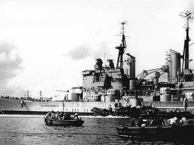 HMS Vanguard with the sea-going tug Advice on the port side attempting to halt her advance into Point. Picture: Barry Cox collection.