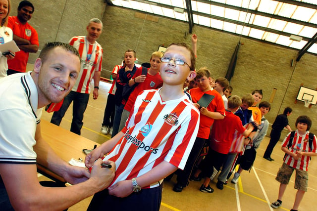 Sunderland footballer David Meyler signs the shirt of 12 year pupil old Andrew Dixon at the St Aidan's School charity football shirts day.  Pupils were helping to raise money for the education of children in Tamil Nadu, India. But who can tell us which year this was?