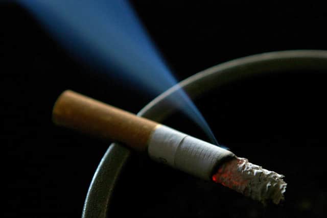 A cigarette burning on an ash tray. The age at which people can legally buy tobacco in England should rise from 18 by one year every year, a government-commissioned review has recommended. Photo: PA