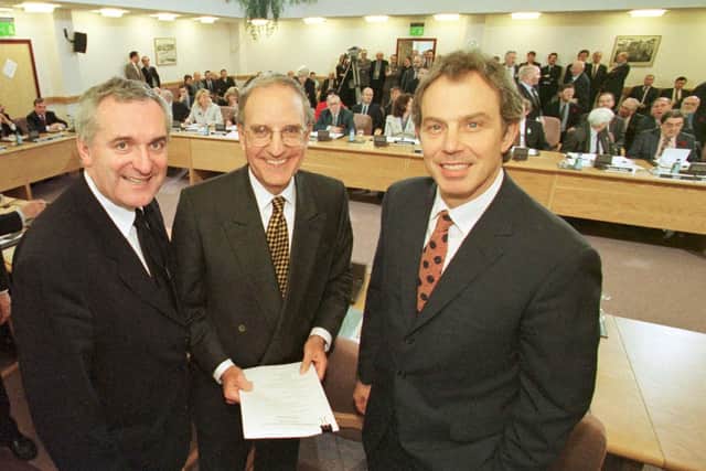 Bertie Ahern, Senator George Mitchell and Tony Blair after the signing of the agreement on April 10 1998
