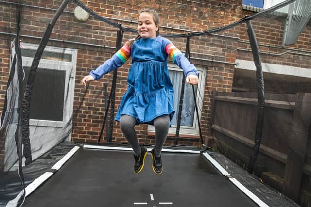 Maddi Crockford-Reid (13) enjoys the trampoline provided by Family Fund, which will act act as a form of physiotherapy. Picture: Mike Cooter (220521)