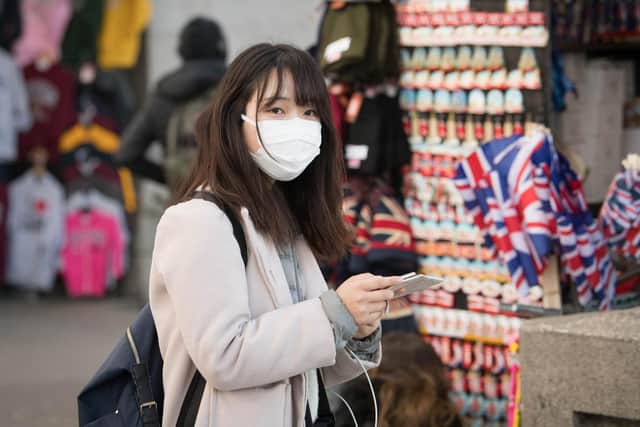 A woman wearing a face mask in London. Picture: Stefan Rousseau/PA Wire