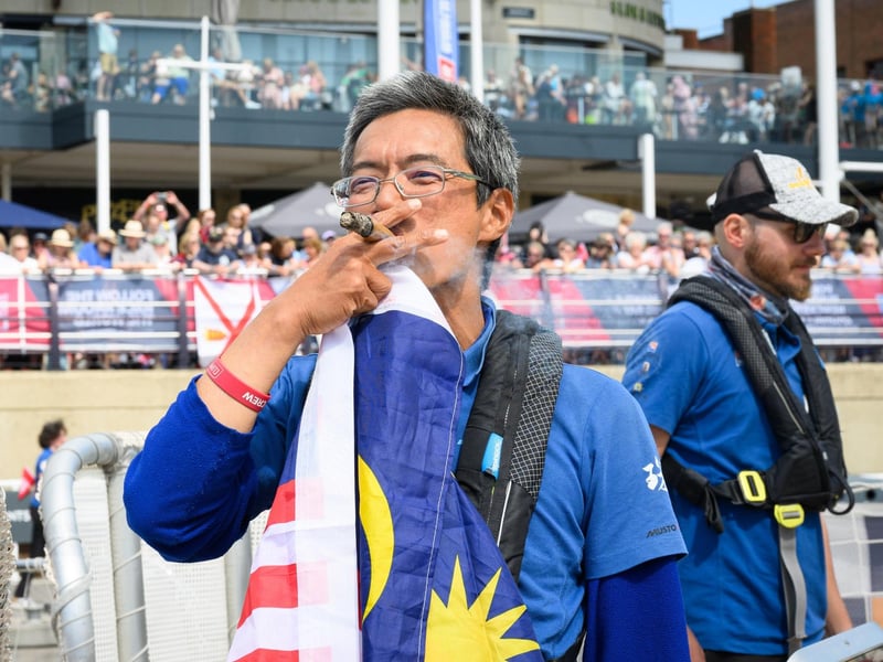 A sailor from Malaysia celebrates with a cigar.Picture: Keith Woodland (270721-38)