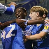 Members of Pompey's Academy celebrate Koby Mottoh's stoppage-time goal in Tuesday night's 5-2 victory over Southampton. Picture: Jason Brown/ProSportsImages