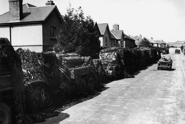 American Army vehicles disguised with camoflague netting, parked along a road in the English suburbs, June 1944. (Photo by Keystone/Hulton Archive/Getty Images)