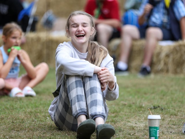 Margo Hodges, 13, enjoys watching Silly Scott perform at All Saints Church, Denmead on Saturday, August 16. Picture: Chris Moorhouse (160825-27)