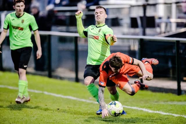 Liam Hibberd, middle, fouls Nathan Paxton during Alresford's win at AFC Portchester last December. The former Fareham player has now signed for the Royals. Pic: Keith Woodland