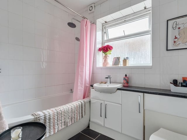 The bathroom is modern and comes with a shower over the bath.