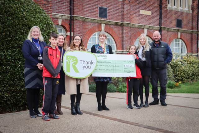 Cheque presentation to Rowans Hospice: Mrs Amy Wilson-Smith (far left), PGS staff and pupils handover their donation to Rowans Hospice. Far right of picture are Adrian and Aimee Jennings.