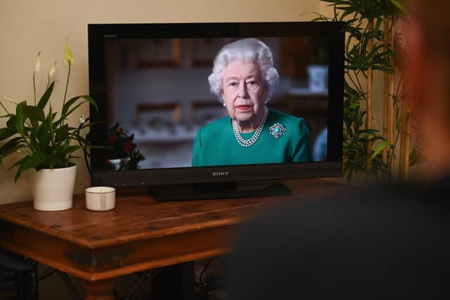 People in Wandsworth, London, watch Queen Elizabeth II deliver her address to the nation and the Commonwealth in relation to the coronavirus epidemic. Photo: Kirsty O'Connor/PA Wire