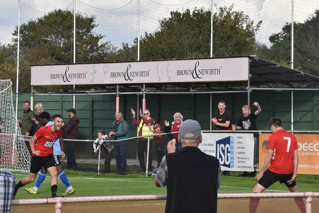 Bailey Newbury, left, runs over to celebrate after heading in a cross from Dan Bennett (7). Picture: Paul Proctor