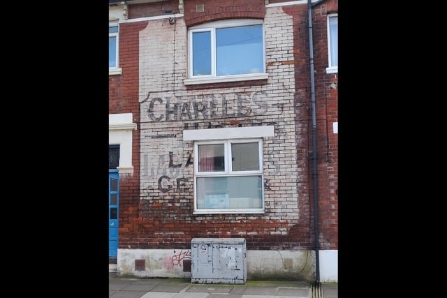 A faded ghost sign at the west end of Manners Road reads: 'Charles Ladies Gents'.