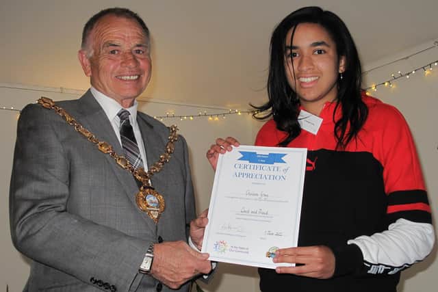 Volunteer, Chelsea Garry, from the organisation Level Up Gosport, being presented her volunteer award by The Mayor of Gosport, Cllr. Jamie Hutchison.