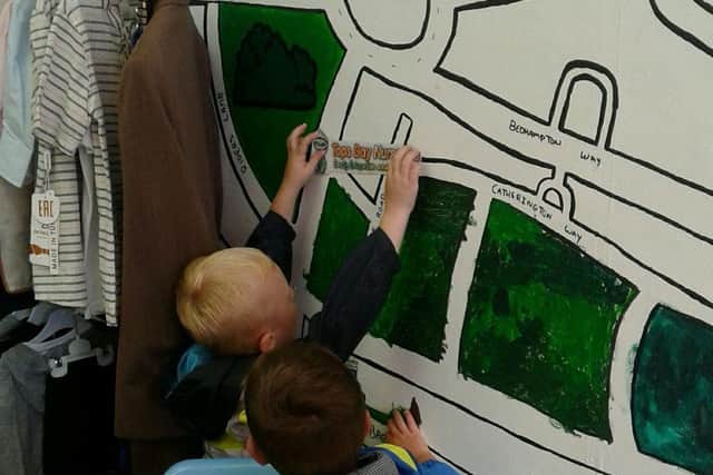 Tops Day Nurseries Havant add their logo to the community wall.