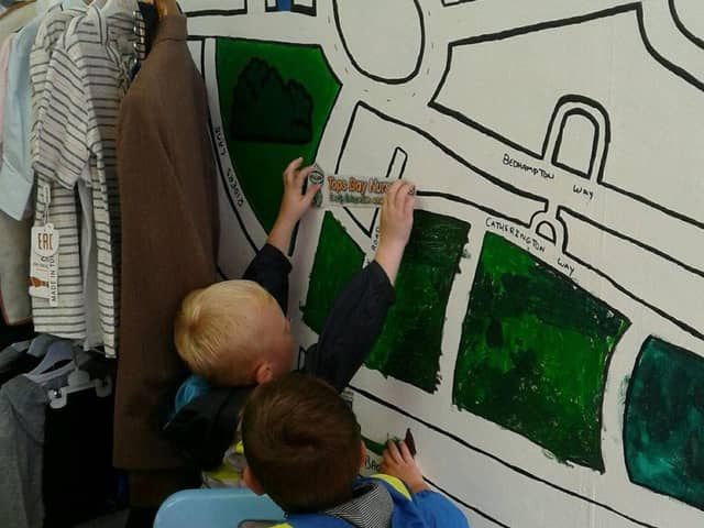 Tops Day Nurseries Havant add their logo to the community wall.