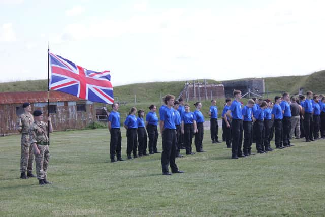 The students standing to attention.