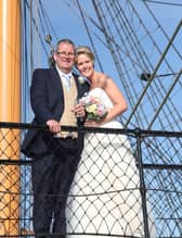 Martin and Angela posing on the historic stairwell of HMS Warrior on their wedding day, 2015.