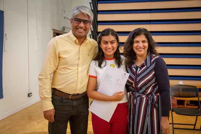 Pictured: Jim Khan, with his daughter Ashlyn and his wife, Sadaf. celebrating Ashlyn's A-level results at Portsmouth High School on August 17, 2023. Picture: Habibur Rahman