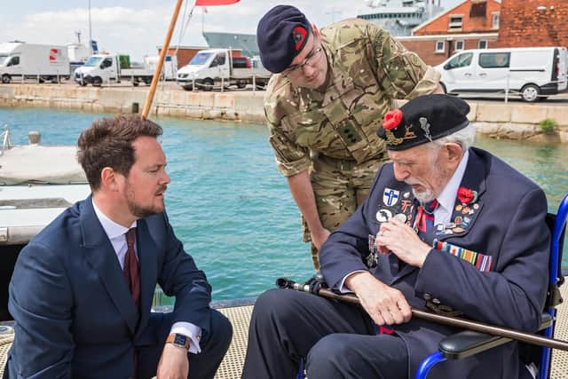 D-Day veteran Joe Cattini (98) relays the stories behind his many medals to Stephen Morgan (Shadow Armed Forces Minister) at Portsmouth Naval Base on Armed Forces Day. Picture: Mike Cooter (250621)