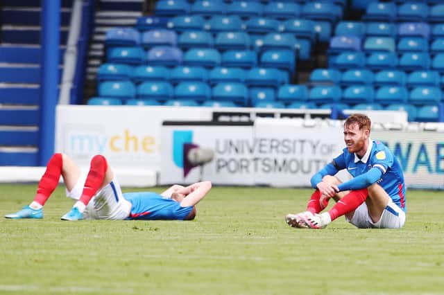 A dejected Jack Whatmough and Tom Naylor after Pompey choked on the final day to miss out on the play-offs. Picture: Joe Pepler
